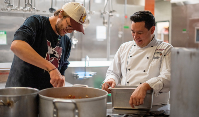 Student and chef John cooking pasta sauce