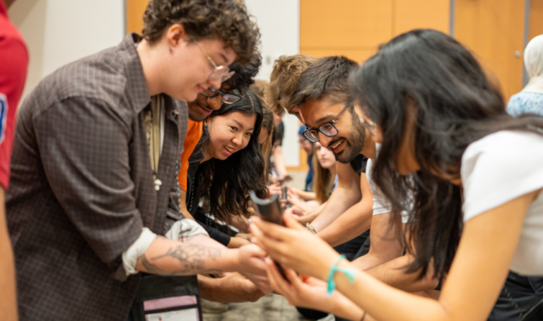 Students at a conference participating in a teamwork activity