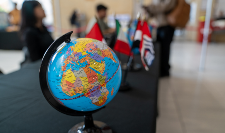 Globe on a desk during a fair on campus