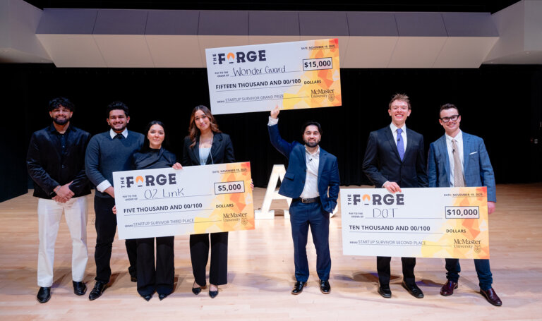 Startup Survivor winners with large-format cheques.
