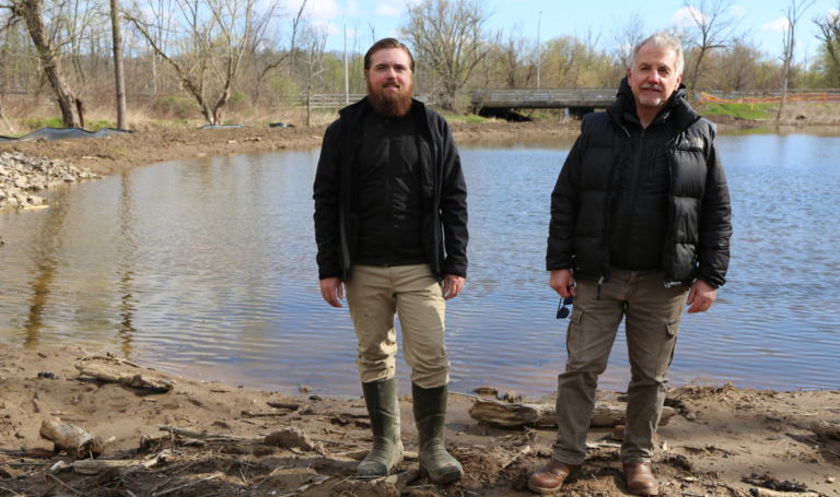 Staff Noah and Wayne by west campus marsh.