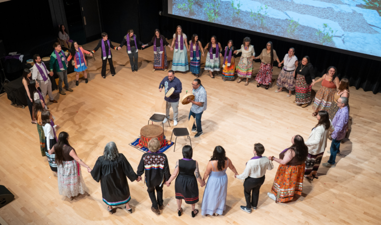 Round dance on stage at the Indigenous Graduate Celebration.