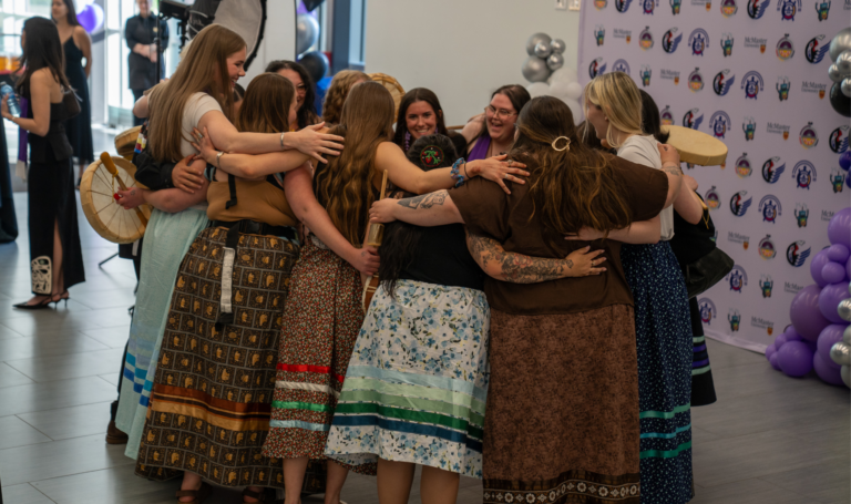 Group hug at Indigenous Graduate Celebration.