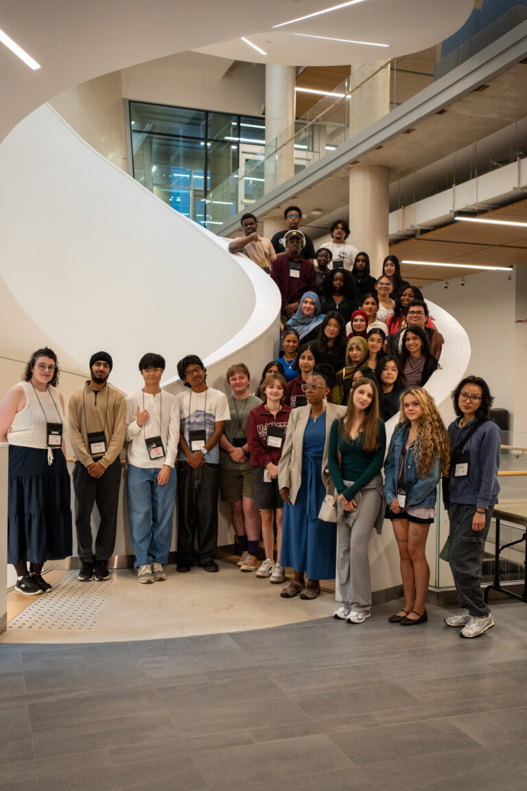 Large group of Mac4U participants on winding staircase.