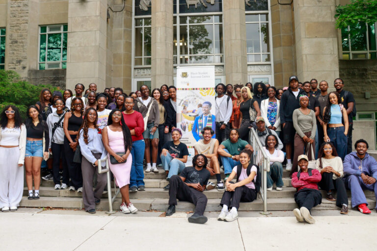 Large group of students around a banner for the Black Student Success Centre.