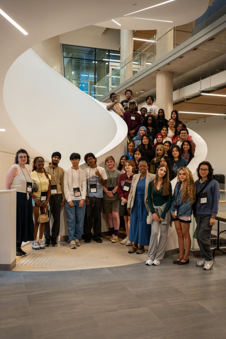 Large group of Mac4U participants on winding staircase.