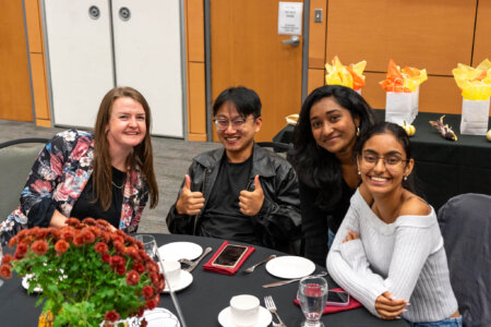 Students around table at Harvest Dinner.