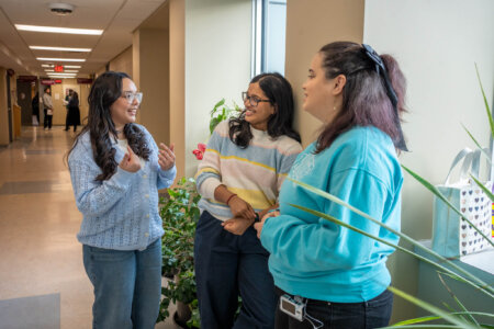 Students chatting in hallway.