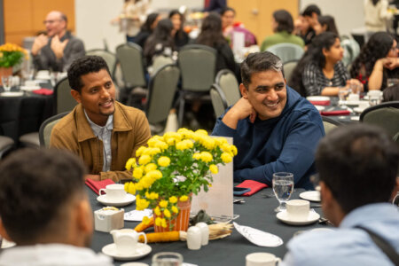 Crowd seated at tables for harvest dinner