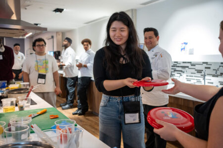 Students and chefs during cooking event