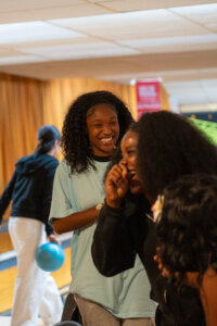 Students laughing at bowling alley