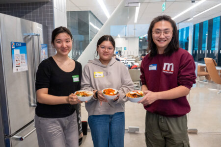 Students holding up dishes they made during event